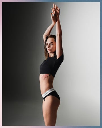 Woman posing with arms raised