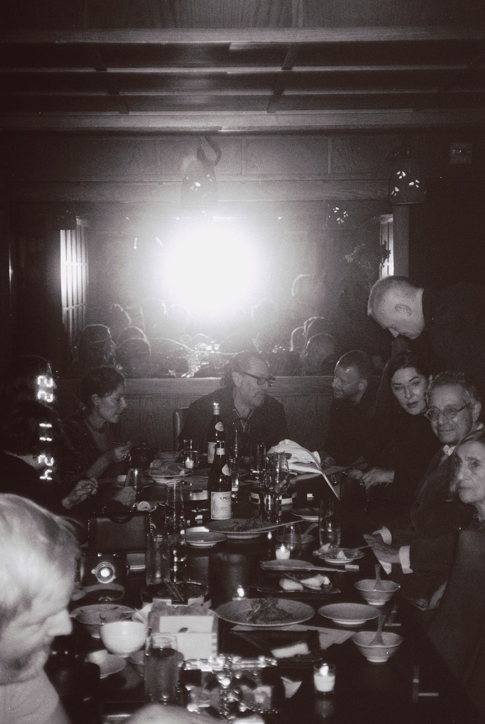 gathering at a dining table with food and drinks