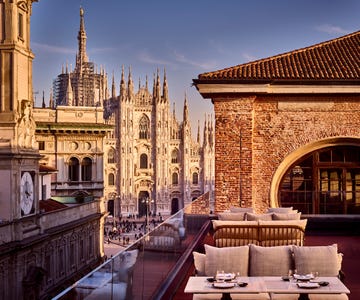 a courtyard with a building in the background