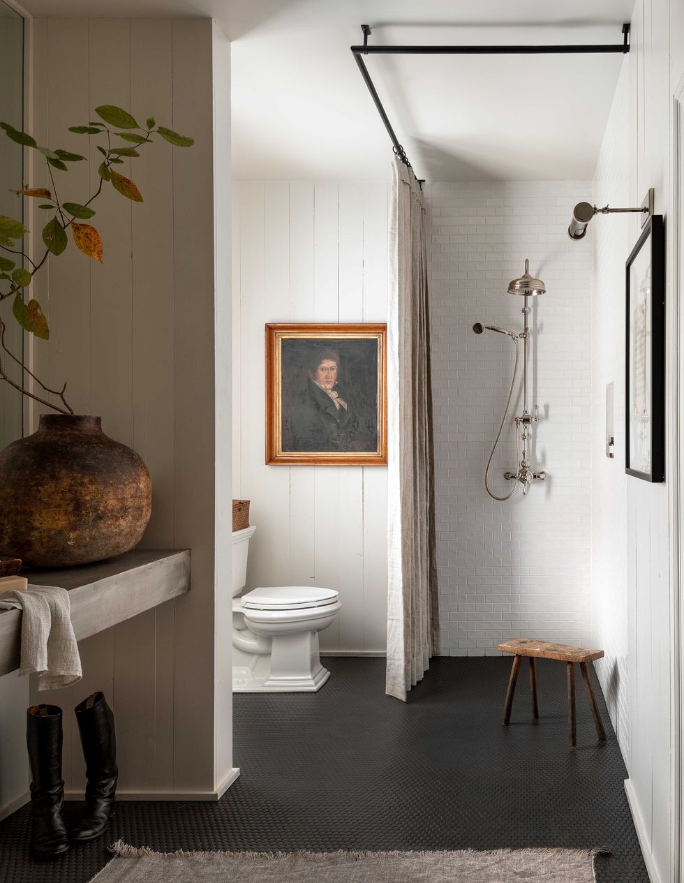black tiles, white painted bathroom, brick and wood panelling