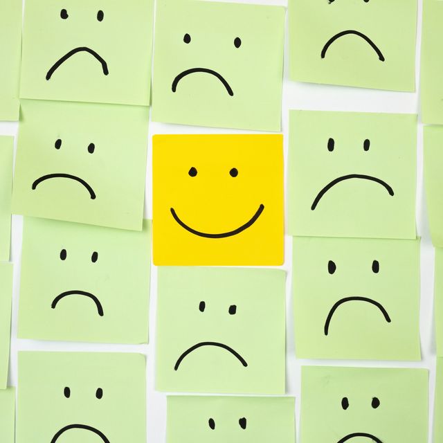 sad faces on sticky notes with one happy one