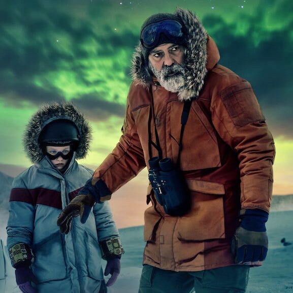 an adult scientist stands with a child against the northern lights in a scene from the midnight sky, a good housekeeping pick for best sad movies on netflix