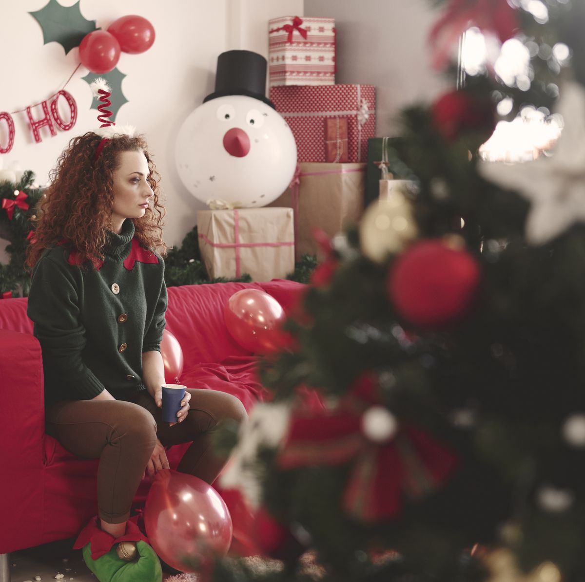 https://hips.hearstapps.com/hmg-prod/images/sad-young-woman-sitting-alone-on-sofa-at-christmas-royalty-free-image-1568829463.jpg?crop=0.670xw:1.00xh;0.154xw,0&resize=1200:*