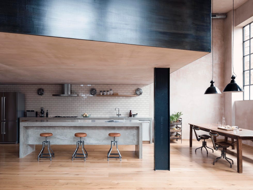 open plan kitchen diner with mininalist grey island and black steel beam