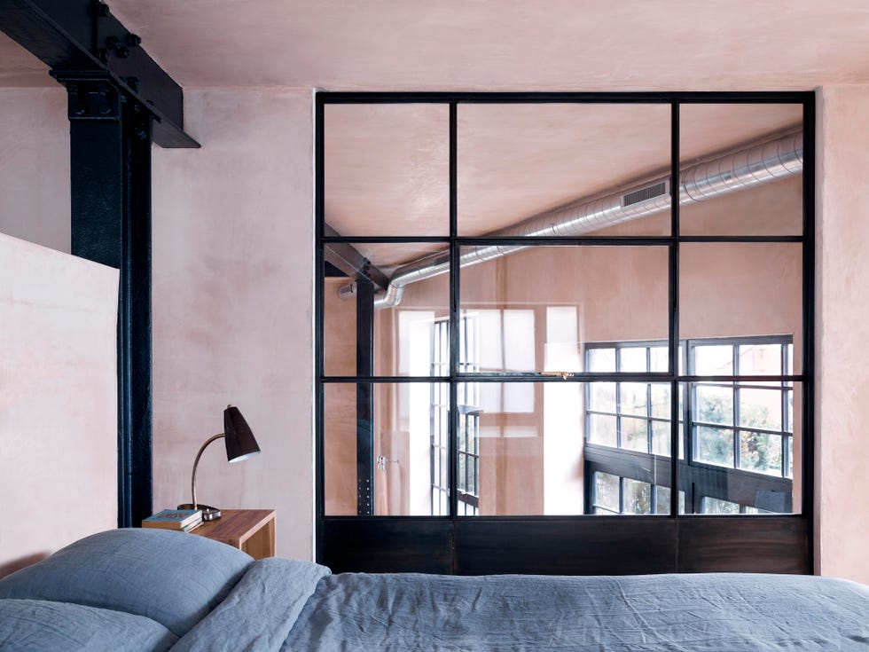 modern bedroom featuring a distinctive glass partition