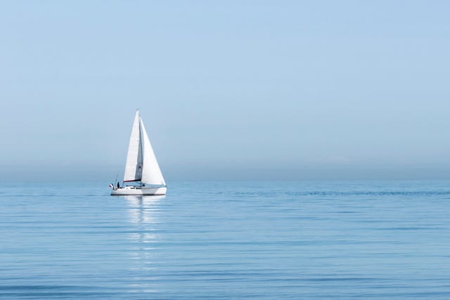 sailboat sailing on sea against clear sky