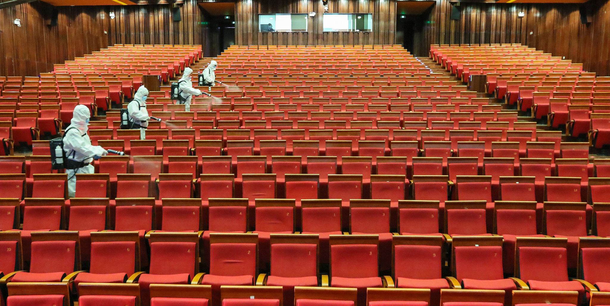 topshot   this photo taken on may 12, 2020 shows staff members spraying disinfectant at a theatre as it prepares to reopen in yantai in china's eastern shandong province   china's top decision making body has given the green light for cinemas, entertainment venues and sports facilities nationwide to reopen after several months of closures photo by str  afp  china out photo by strafp via getty images