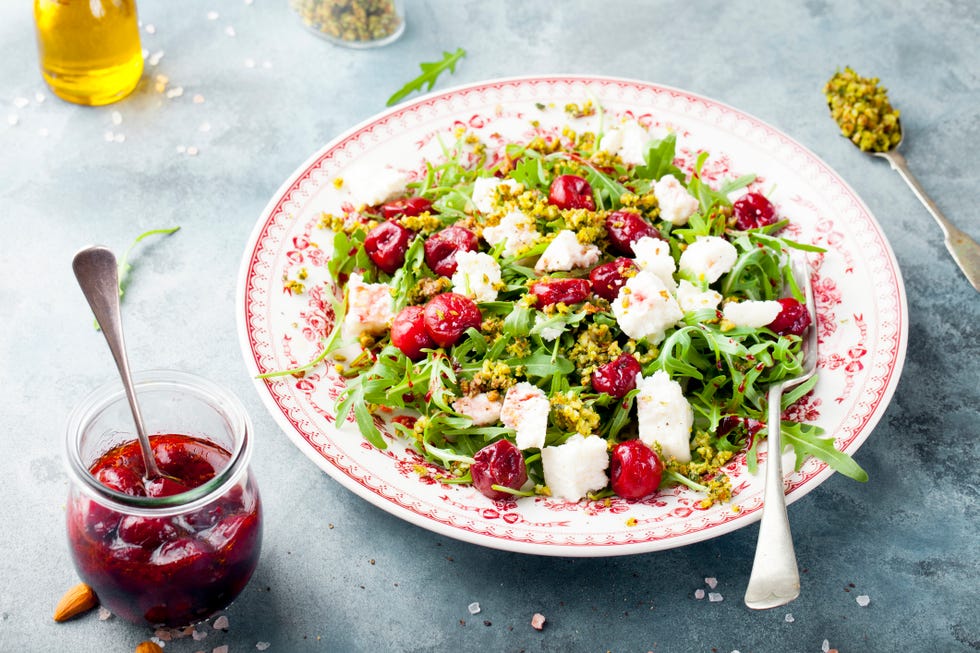 salad with arugula,cherries and goat cheese on a blue background,romania