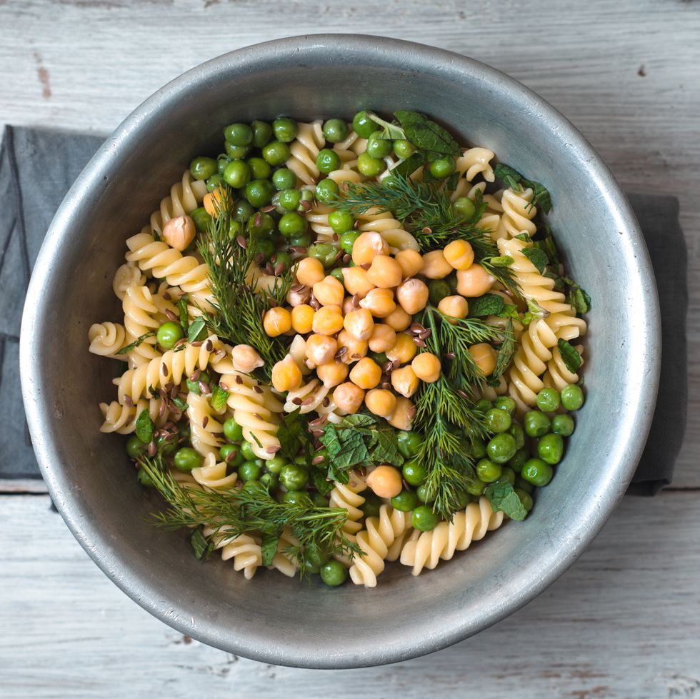 Salad with fusilli, chickpeas, grass in a metal bowl