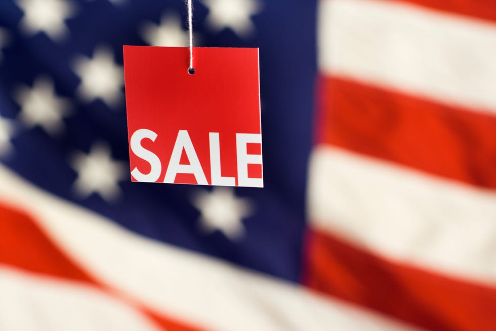 4th of july sale sign in front of flag, good housekeeping's favorite 4th of july activities