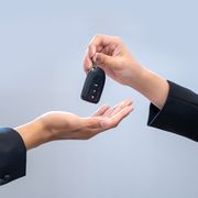 salesperson hands car keys to a customer after a successful financing agreement