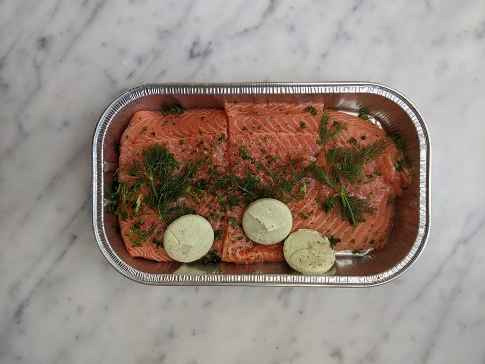 best costco prepared meals kirkland signature salmon milano topped with basil pesto butter in aluminum tray
