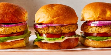 salmon burgers topped with lettuce, tomato, and sliced red onion