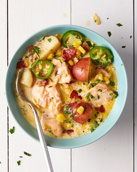teal bowl of salmon chowder with bacon, potatoes, and jalapenos