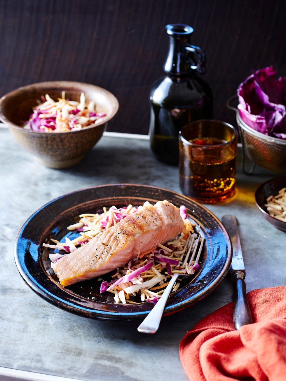 salmon and slaw on a black plate