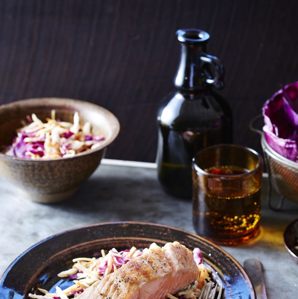 salmon and slaw on a black plate
