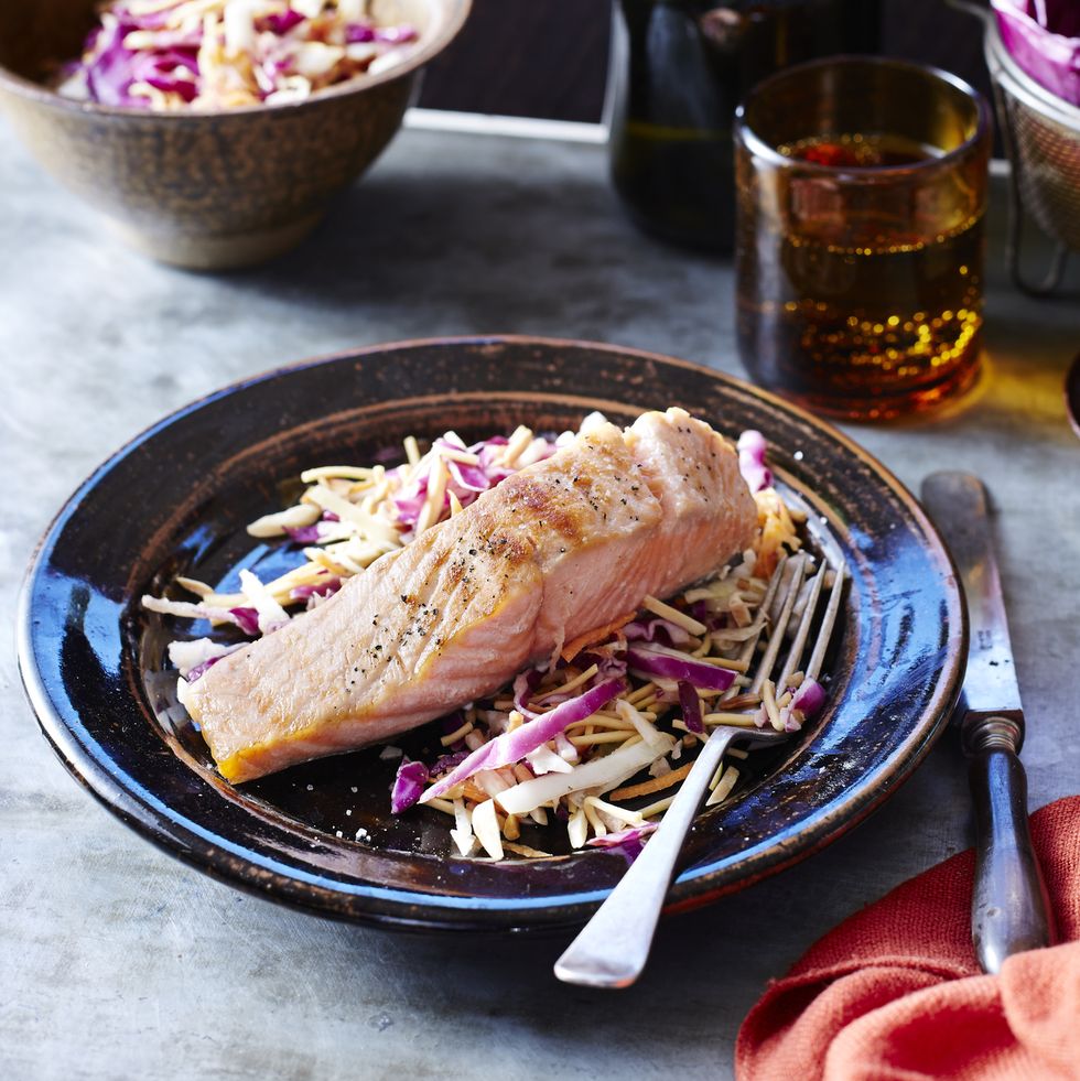 salmon and slaw on a black plate