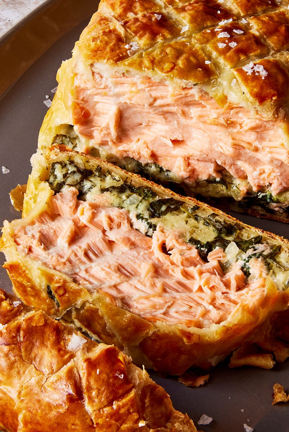layers of salmon and cream spinach inside of puff pastry