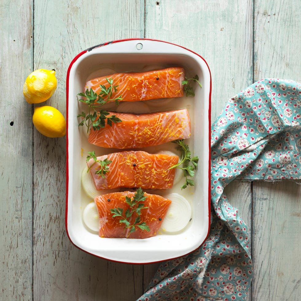 salmon in a baking dish with lemons