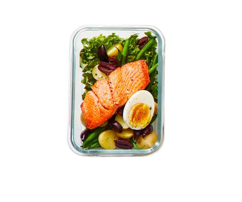 salmon nicoise salad on a white background