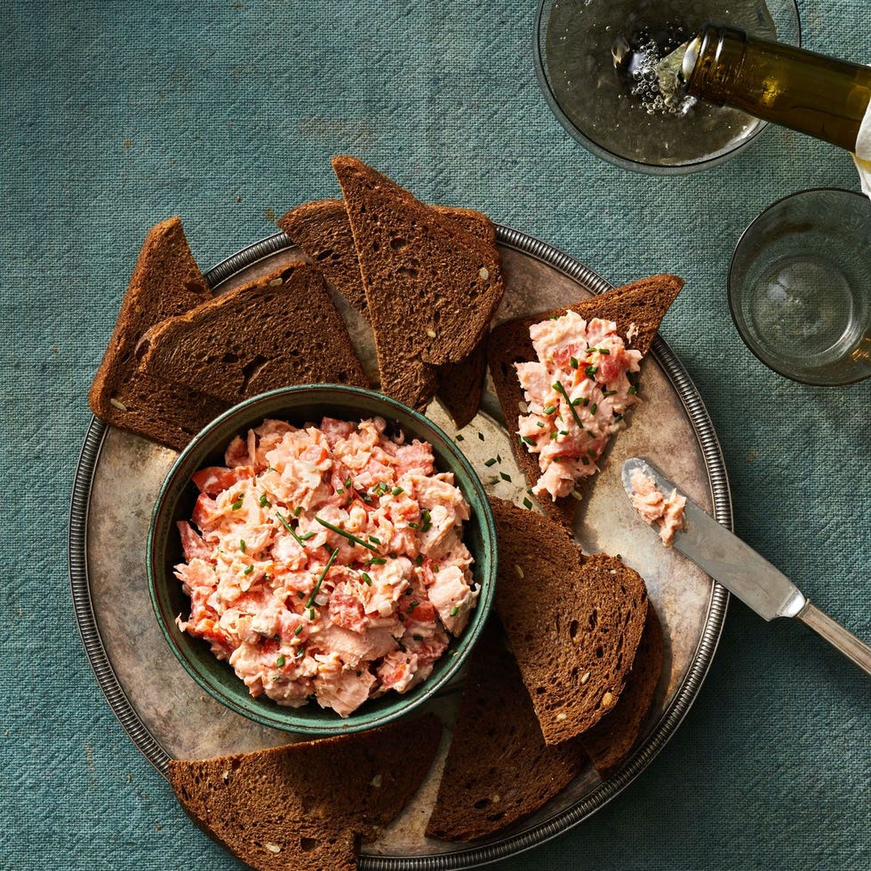 salmon rillettes spread over rye bread toast on a serving platter