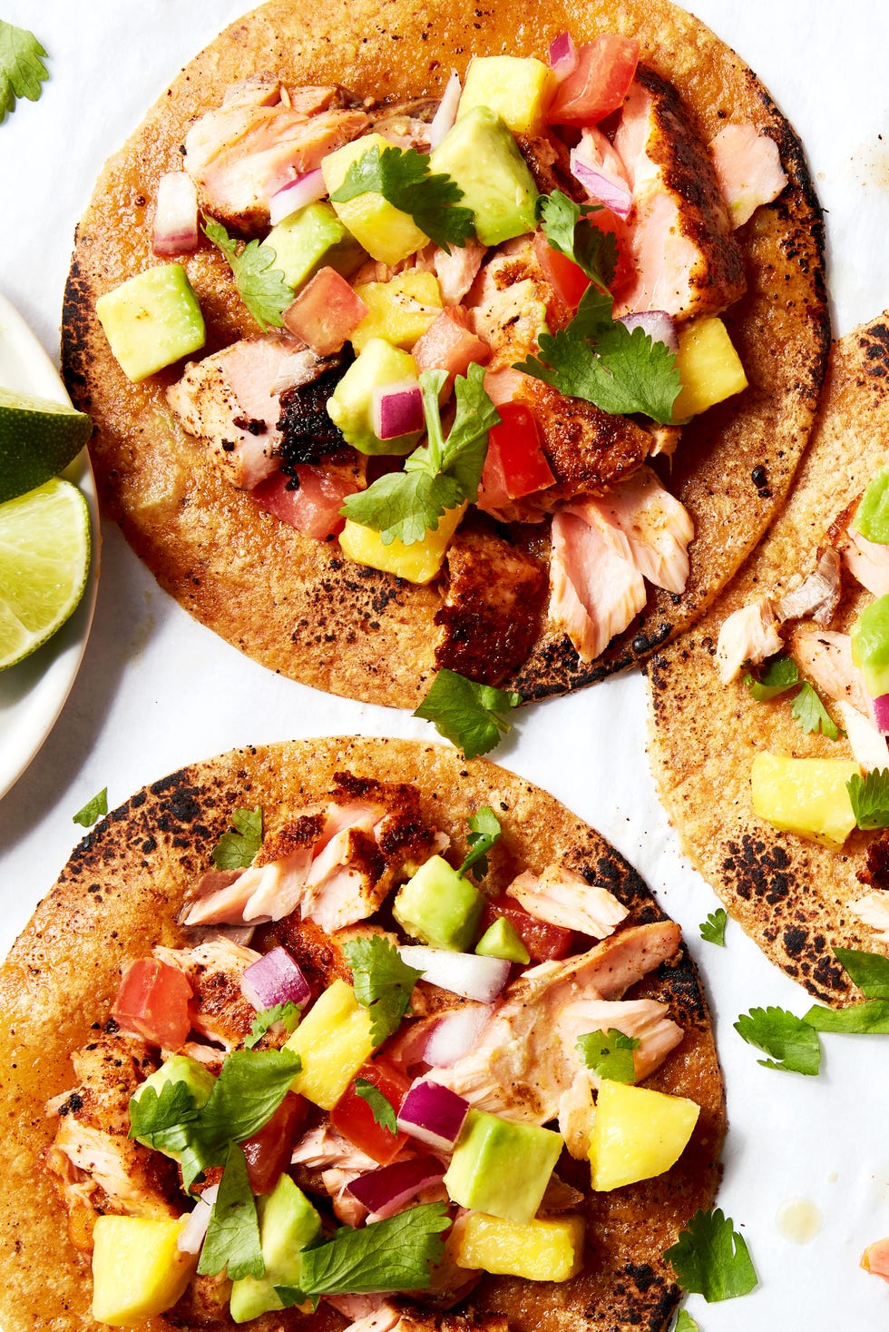 Salmon Tacos salmon tacos topped with mango salsa on a platter
