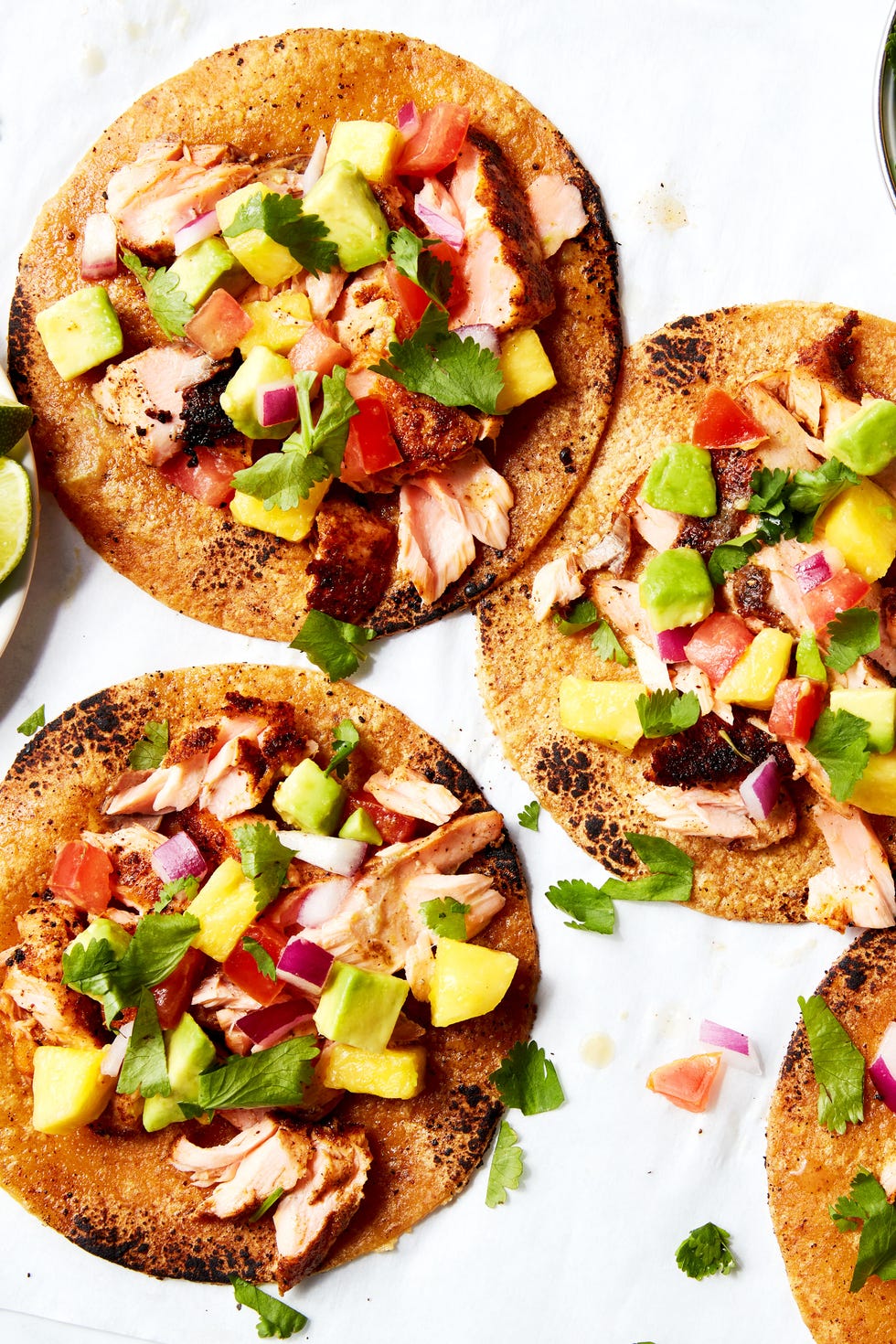 Salmon tacos Salmon tacos topped with mango salsa served on a platter