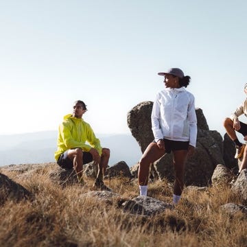 group of three individuals in athletic clothing on rocky terrain group of three individuals in athletic clothing on rocky terrain