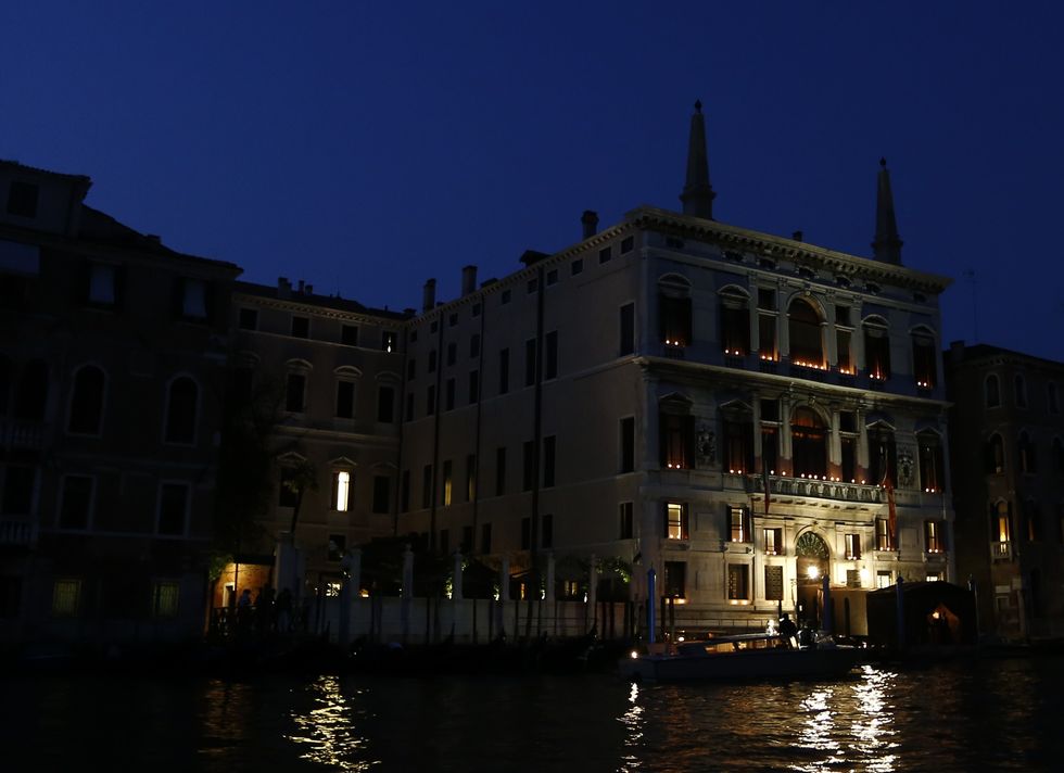 the palazzo papadopoli, hotel aman, is pictured at night on september 27, 2014 in venice where clooney and british fiancee, amal alamuddin celebrate their wedding george clooney has said goodbye to bachelorhood in venice with a stag party at his favourite restaurant with hollywood chums, and was gearing up for a day of glamourous pre wedding celebrations the actor had swept into the floating city yesterday with his british fiancee amal alamuddin on a watertaxi dubbed amore, zipping up the grand canal to cheers from fans at the start of nuptials set to draw out over the weekend     afp photo  pierre teyssot        photo credit should read pierre teyssotafp via getty images