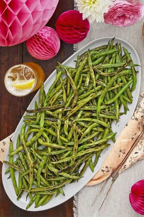 salt and pepper charred green beans on a white plate