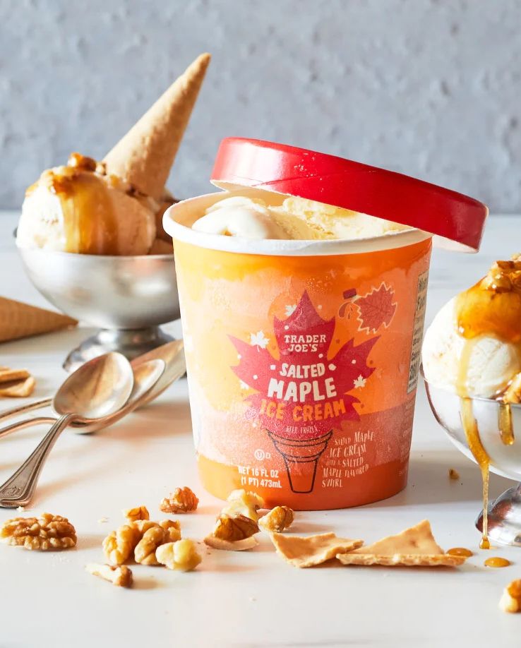 trader joe's salted maple ice cream in silver dishes, topped wtih chopped walnuts, maple syrup and sugar cone pieces