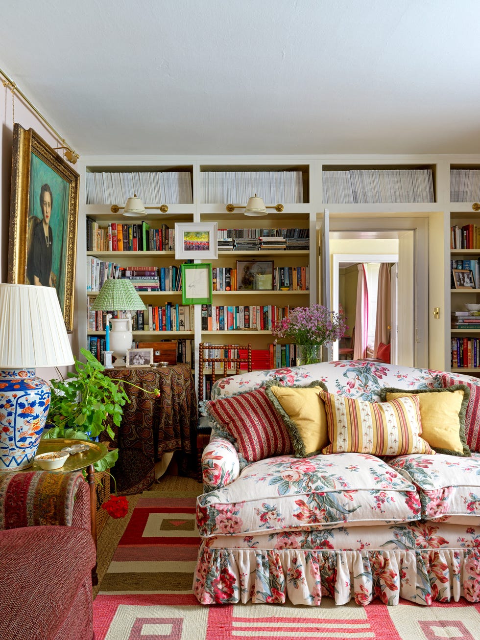 a skirted sofa in the drawing room is awash in hollyhocks, roses, and parrot tulips printed linen, jean monro imari and irish inspired table lamps, vaughan