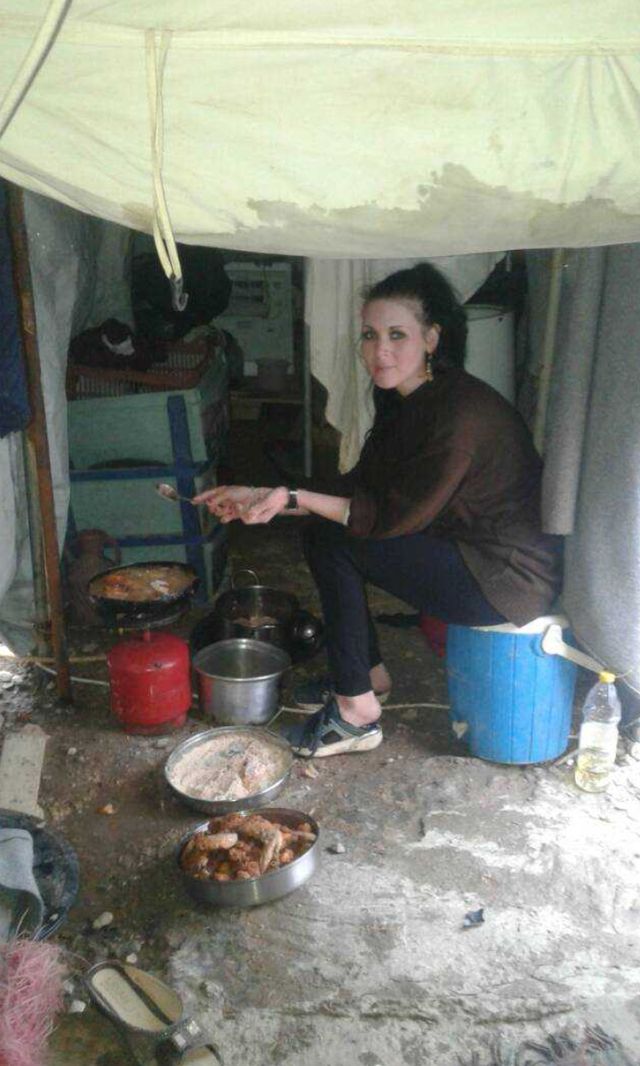 a person cooking food in a tent