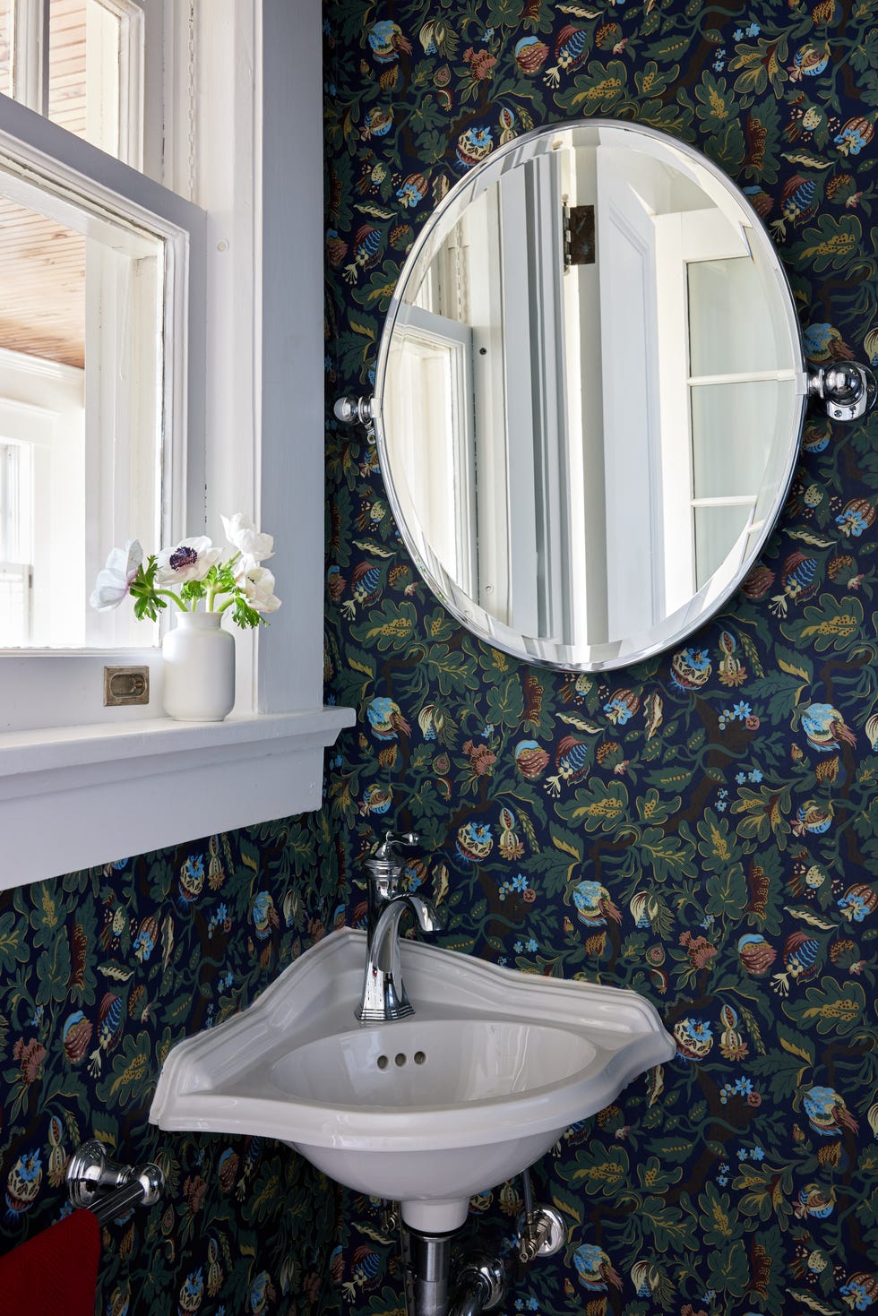 small powder room with navy blue patterned wallpaper