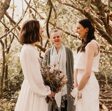 two brides with wedding officiant