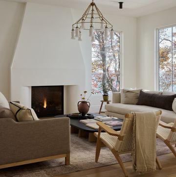 a living room with a chandelier and a fireplace