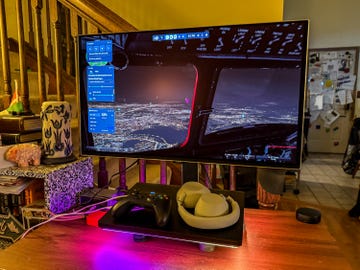 Simulation setup featuring a monitor displaying a flight simulation