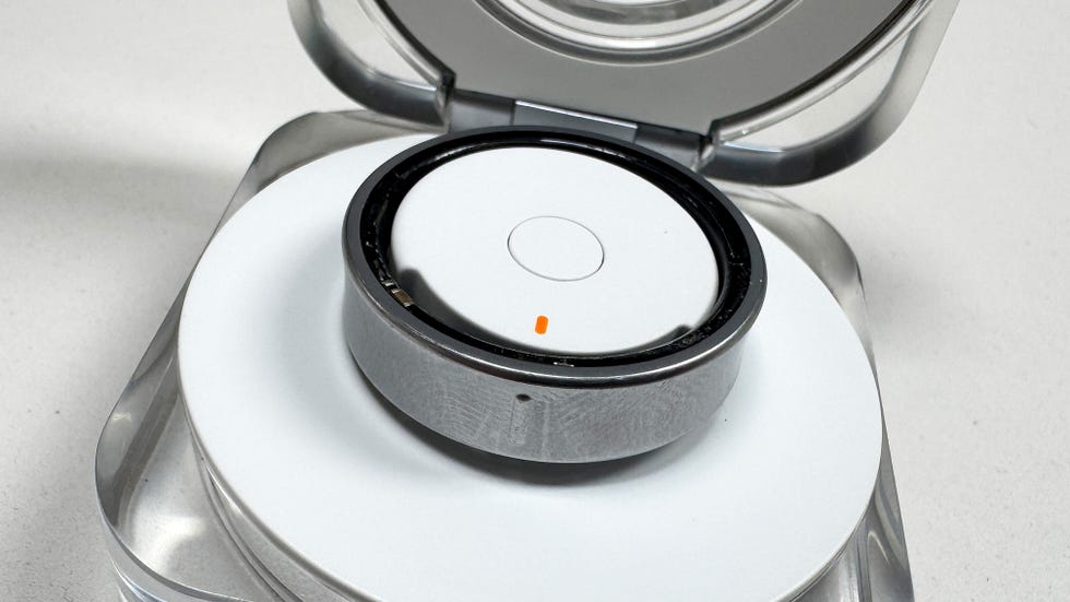 close up of a silver smart ring charging