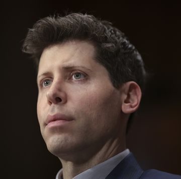 a man looks forward, he wears a suit jacket and collared shirt whose collars are just visible