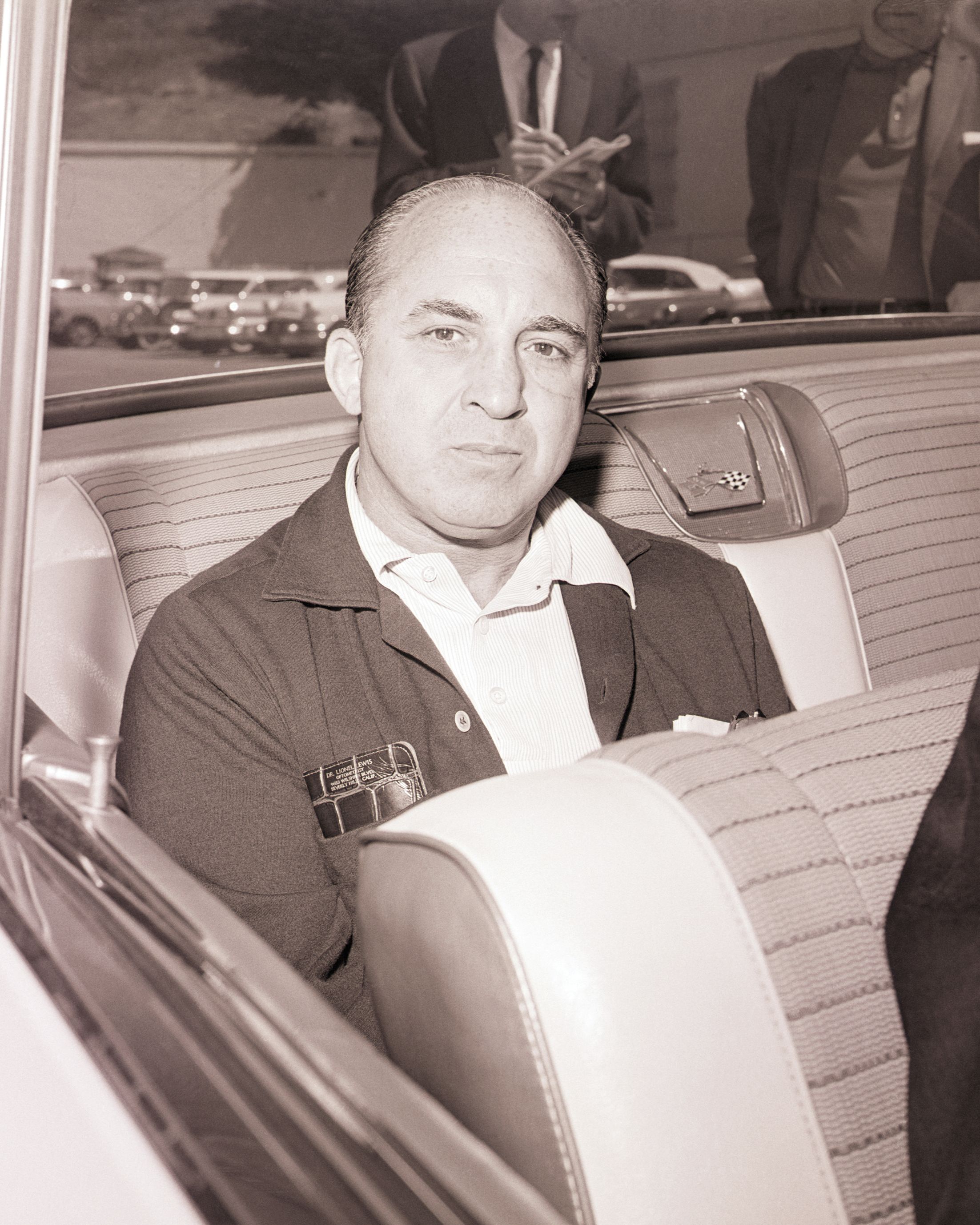 man looking up as he sits in a car