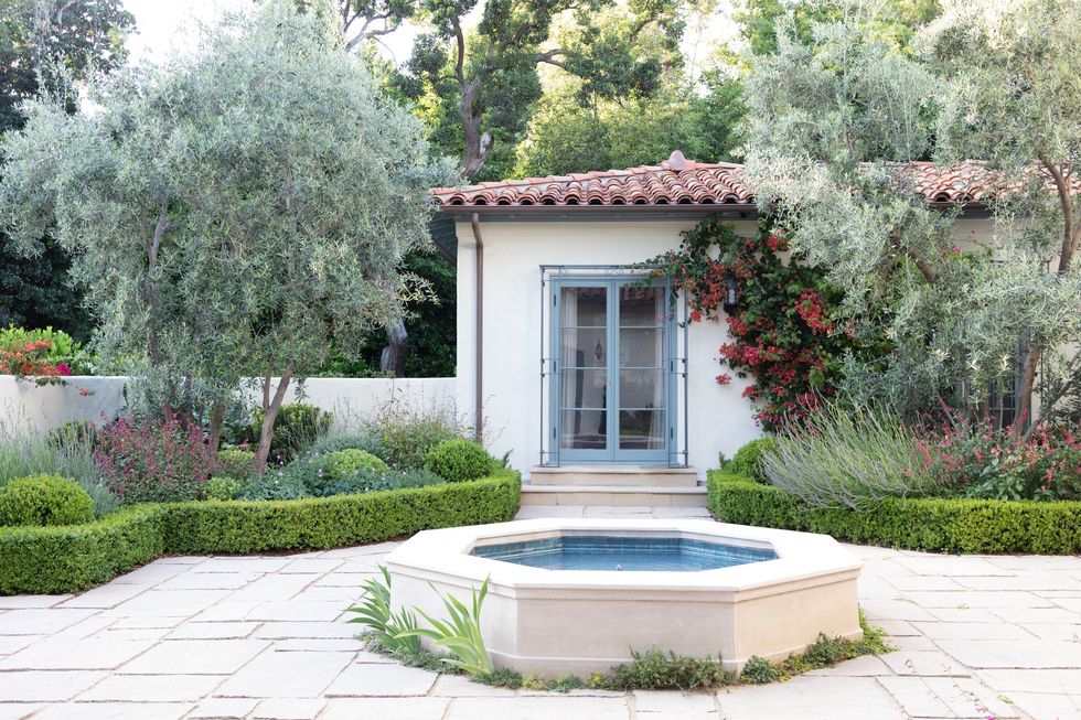 san gabriel valley california home bougainvillea climbs the guesthouse walls olive trees and perennials adorn the courtyard where original paving stones and an octagonal fountain were restored