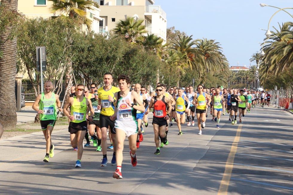 a group of people running on a street