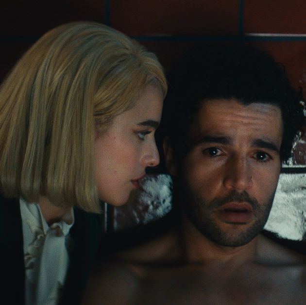 Inside a luxurious, 45th-floor hotel suite, a young, blonde-haired lawyer visits the anxious heir to a hotel empire and begins a business meeting. Armed with a briefcase of documents, Rebecca (Margaret Qualley) runs Hal (Christopher Abbott) through a questionnaire as he prepares to take over his late father's company. But the legal formalities take a hard pivot when Rebecca begins asking about his height, weight, and sexual history. It's not long before she demands that he strip half-naked in the bathroom and scrub the back of the toilet, all while she watches from a chair, reveling in her client's belittled efforts. Though she deviates a bit, Rebecca is just following the script that Hal has written, verbally sparring and embarrassing him without physical contact until she lets him masturbate and climax on the floor.  <br><br>That's how <I>Sanctuary</I>, a sly, sleek, sexy two-hander from director Zachary Wigon and writer Micah Bloomberg, starts its riveting dialectic about power, performance, and identity. When the charade ends (she removes her wig, he puts on his shirt), the pair gorges on some room-service dinner before Hal gifts her a $32,000 watch and informs his longtime dominatrix that he'll no longer need her services. After years of enlisting Rebecca to act out his darkest psychological fantasies, he believes he must rid himself of any sordid liabilities ahead of owning his father's business. 