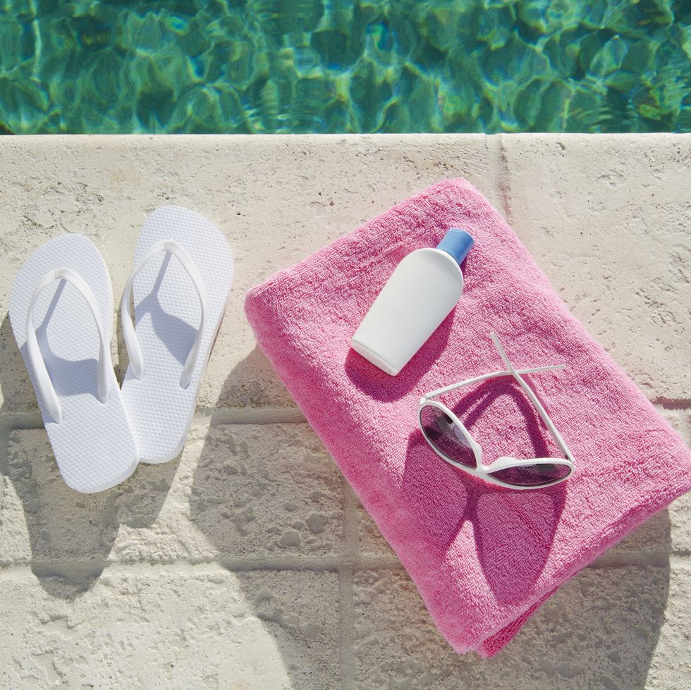 sandals and towel at poolside