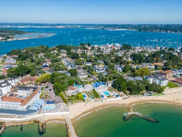 beach front properties on sandbanks with poole harbour with bournemouth in distance