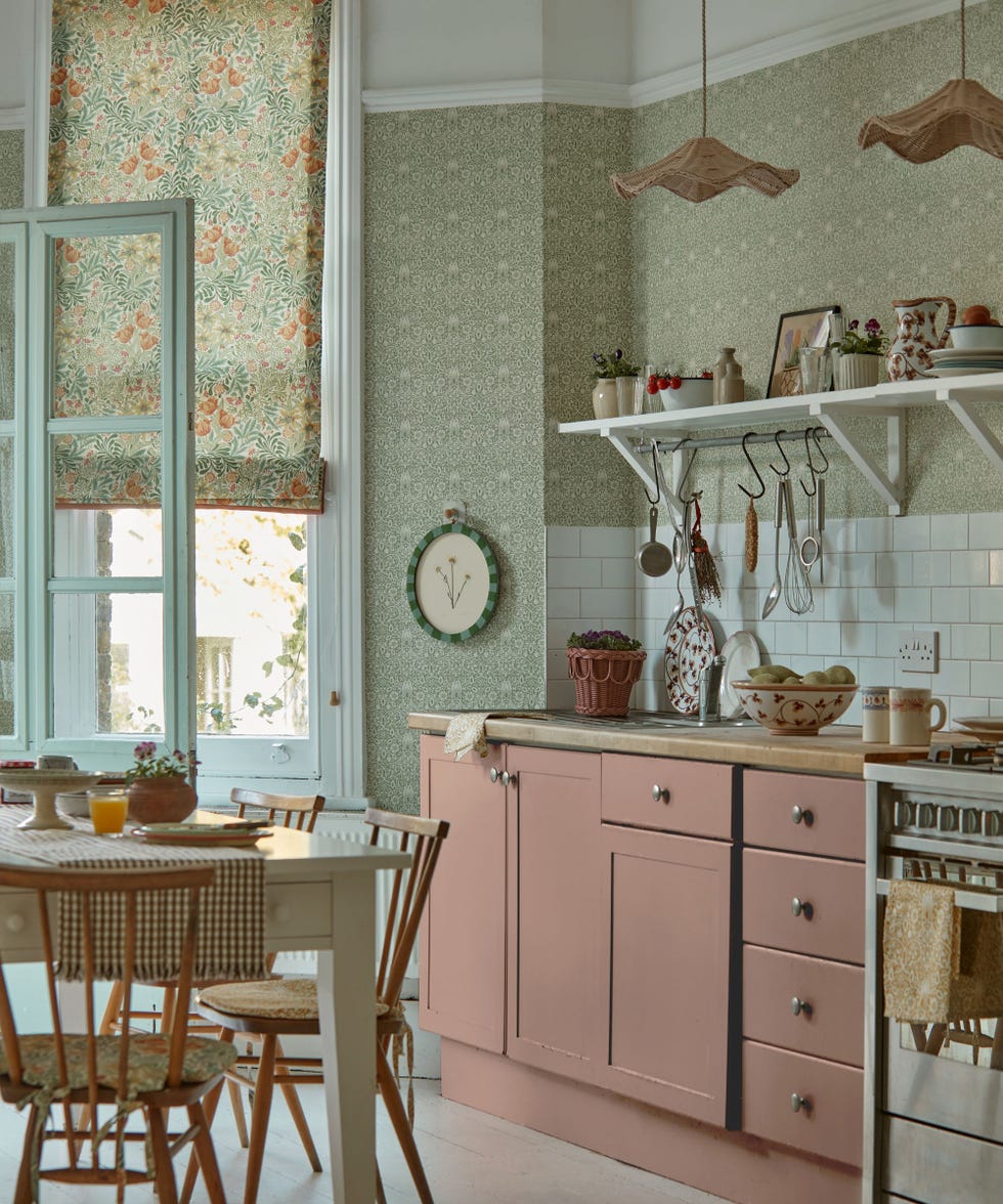 patterned wallpaper and patterned blinds in a pink Shaker-style kitchen