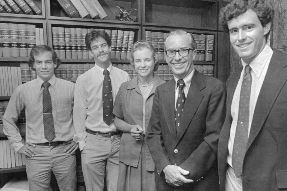 jay o'connor, brian o'connor, sandra day o'connor, john jay o'connor iii, and scott o'connor smile for a photo together while standing in front of a bookshelf