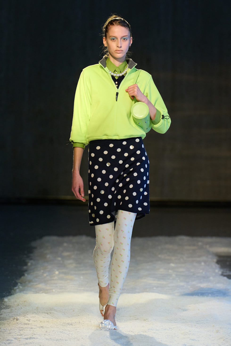 Fashion model showcasing vibrant attire on a runway