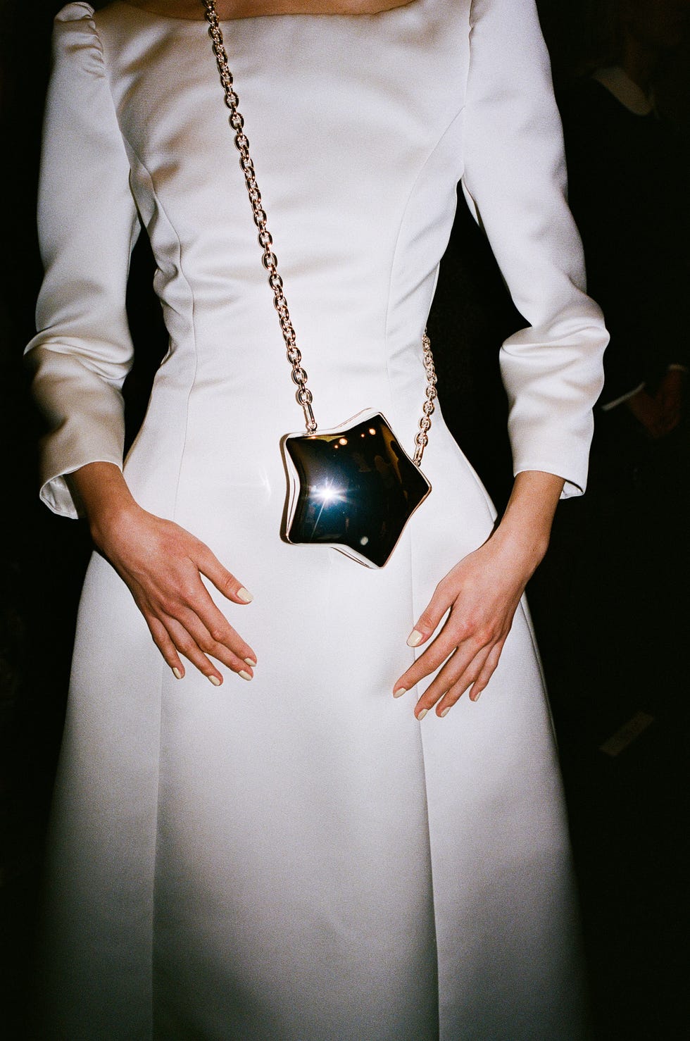 a person wearing a white shirt and a black watch