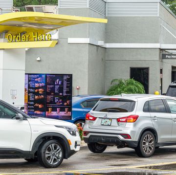 sanford, florida, mcdonald's restaurant drive thru order area, with line of cars